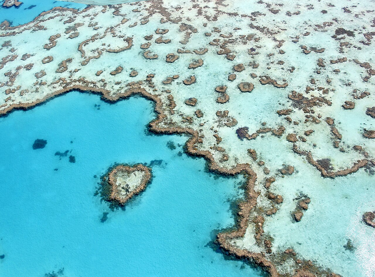 Aerial view of Whitehaven Beach showing swirling patterns of white sand and turquoise water at Hill Inlet