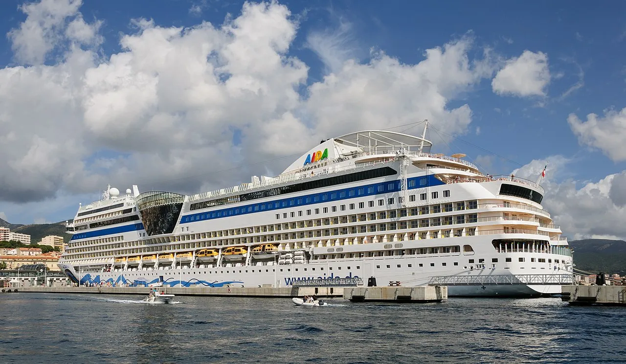 AIDA cruise ship docked at Ajaccio harbor with Corsican mountains