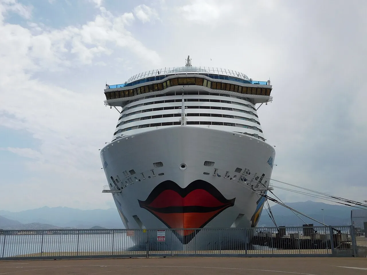 AIDA cruise ship bow with signature red lips at Ajaccio pier