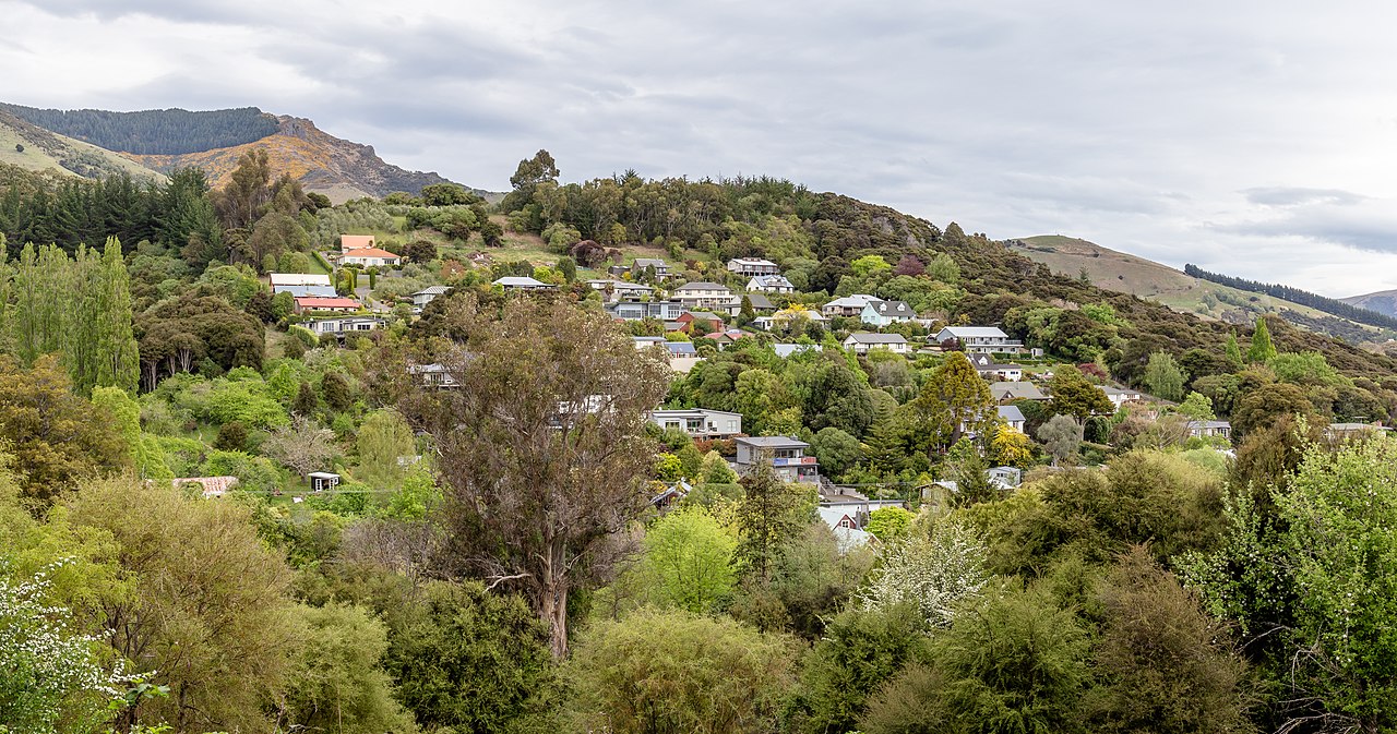 Green volcanic hills of Banks Peninsula rising dramatically around Akaroa harbour