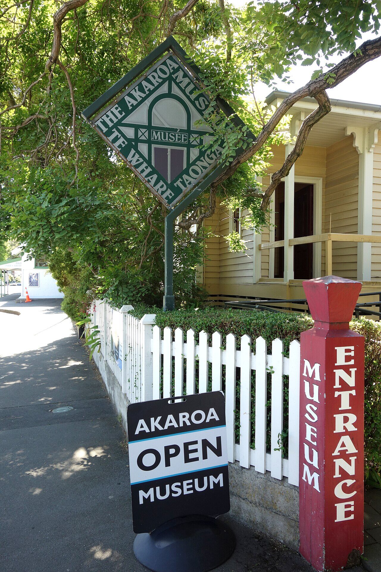 Panoramic view of Akaroa harbour showing volcanic crater rim hills and village waterfront