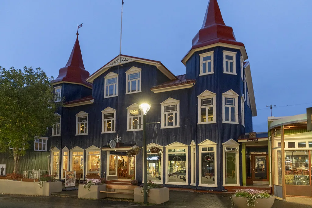 Colorful town of Akureyri nestled along the Eyjafjordur fjord in northern Iceland with snow-capped mountains
