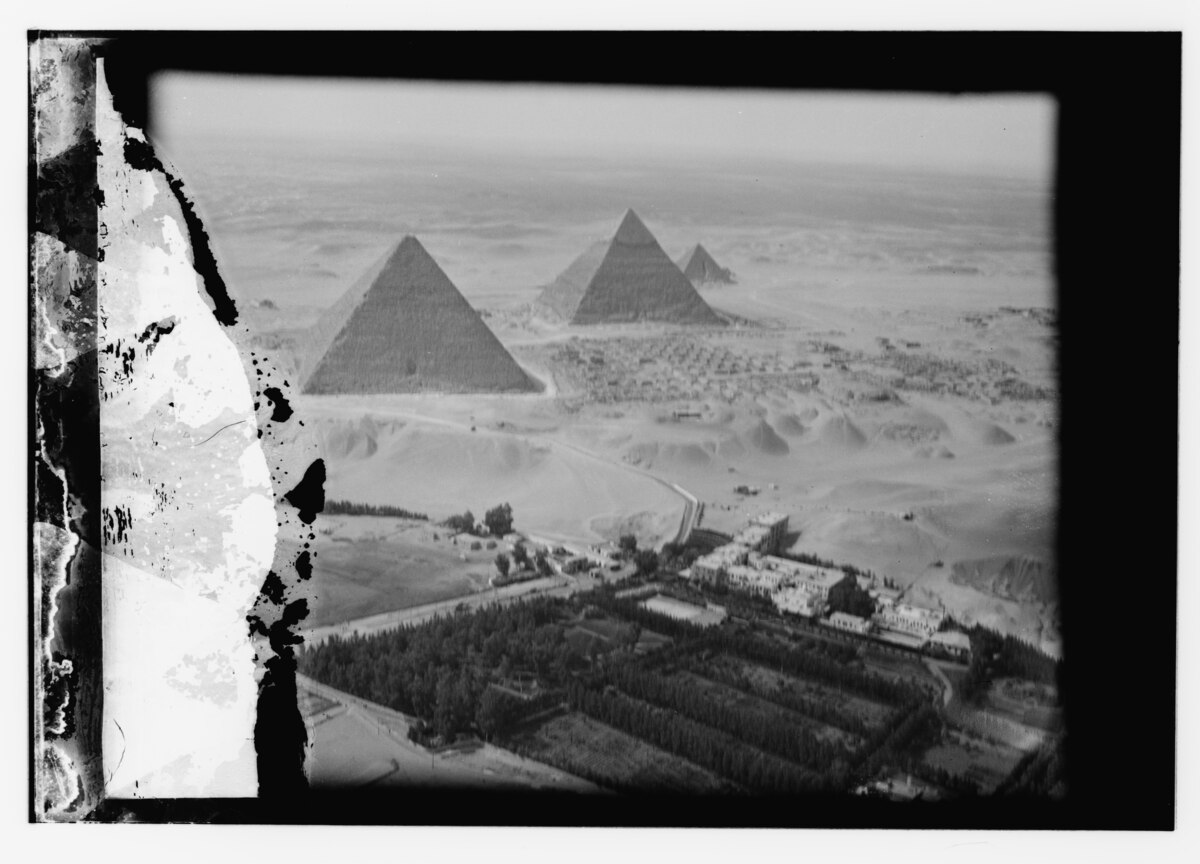 Great Pyramid of Giza with Sphinx in foreground under blue Egyptian sky near Cairo