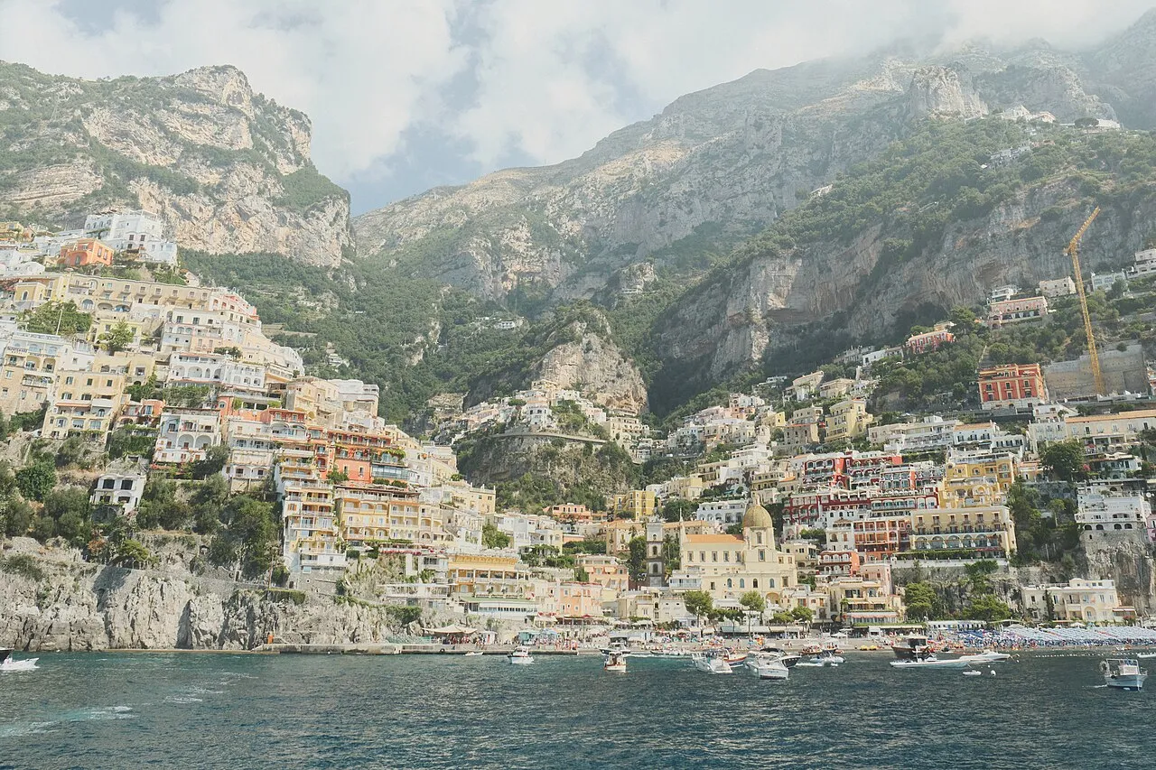 Positano seen from the sea with colorful houses cascading down the hillside
