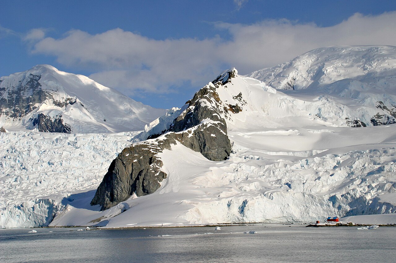 Perfectly still waters of Paradise Harbour reflecting surrounding ice-covered mountains