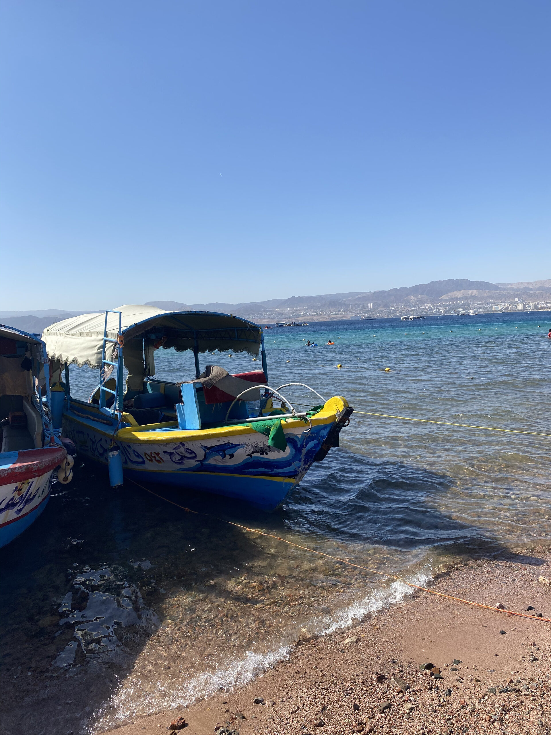Red sandstone rock formations rising from desert floor in Wadi Rum