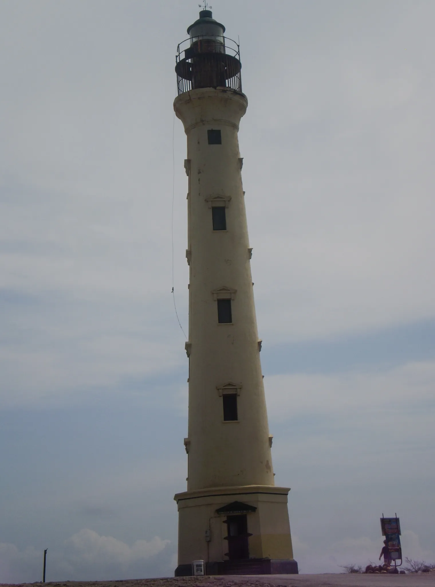 White California Lighthouse standing on rocky headland overlooking the sea