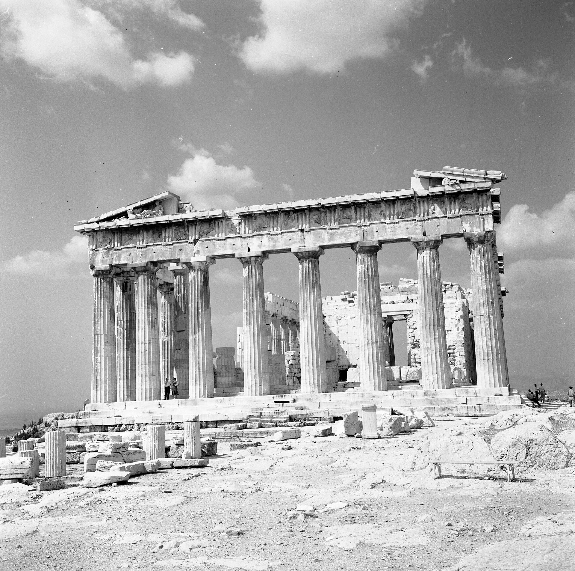 Modern Acropolis Museum building with ancient Parthenon visible on hill above