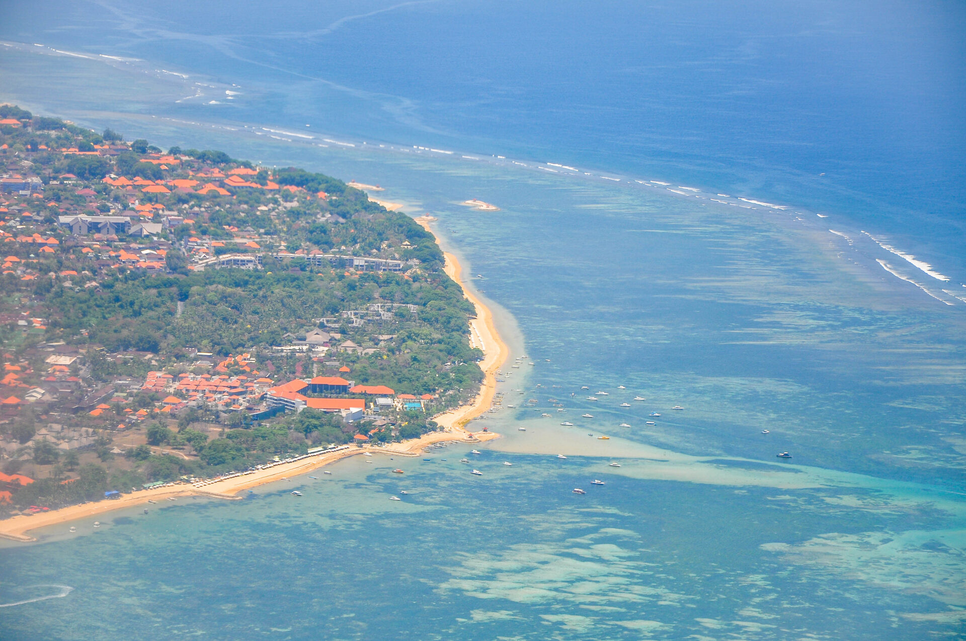 Traditional Balinese canang sari offerings with flowers incense and rice on banana leaves
