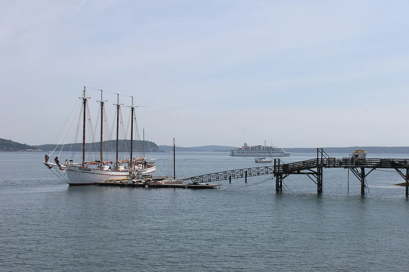 Schooner at pier with cruise ship anchored in Bar Harbor bay