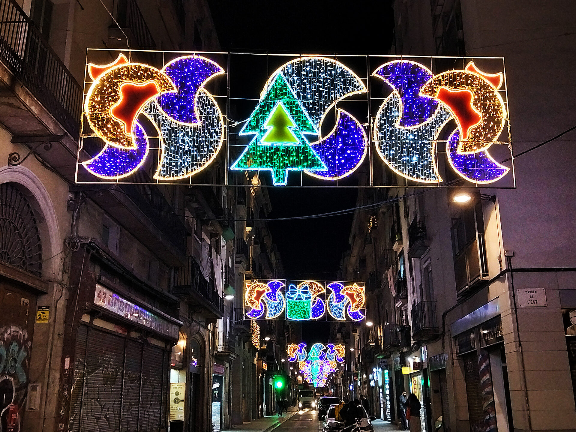 Interior of La Sagrada Familia with soaring columns and stained glass windows casting colored light