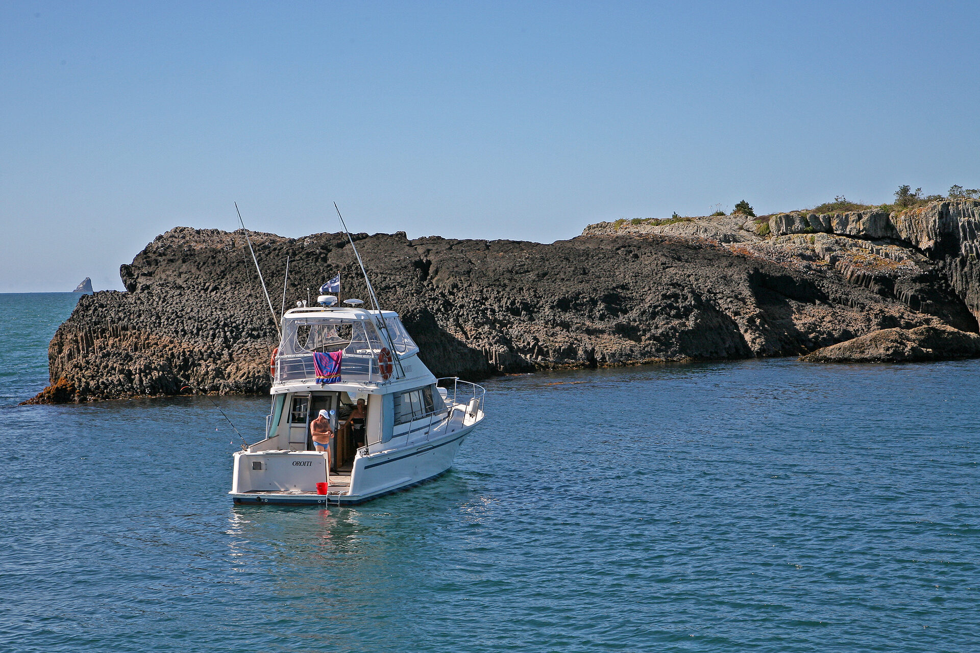 Turquoise waters dotted with 144 subtropical islands rising from the bay under blue New Zealand sky