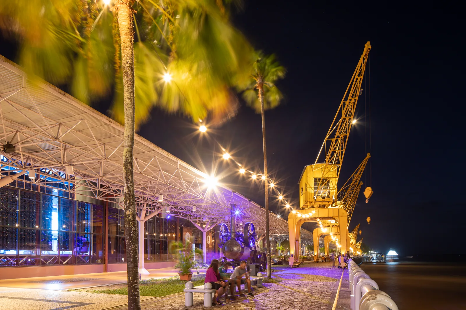 The Estação das Docas warehouses at Belém from the water, three long buildings with the old port cranes in front