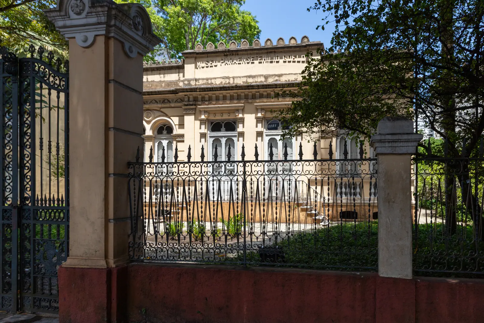 The Museu Paraense Emílio Goeldi seen from the street through the ironwork of its park railings