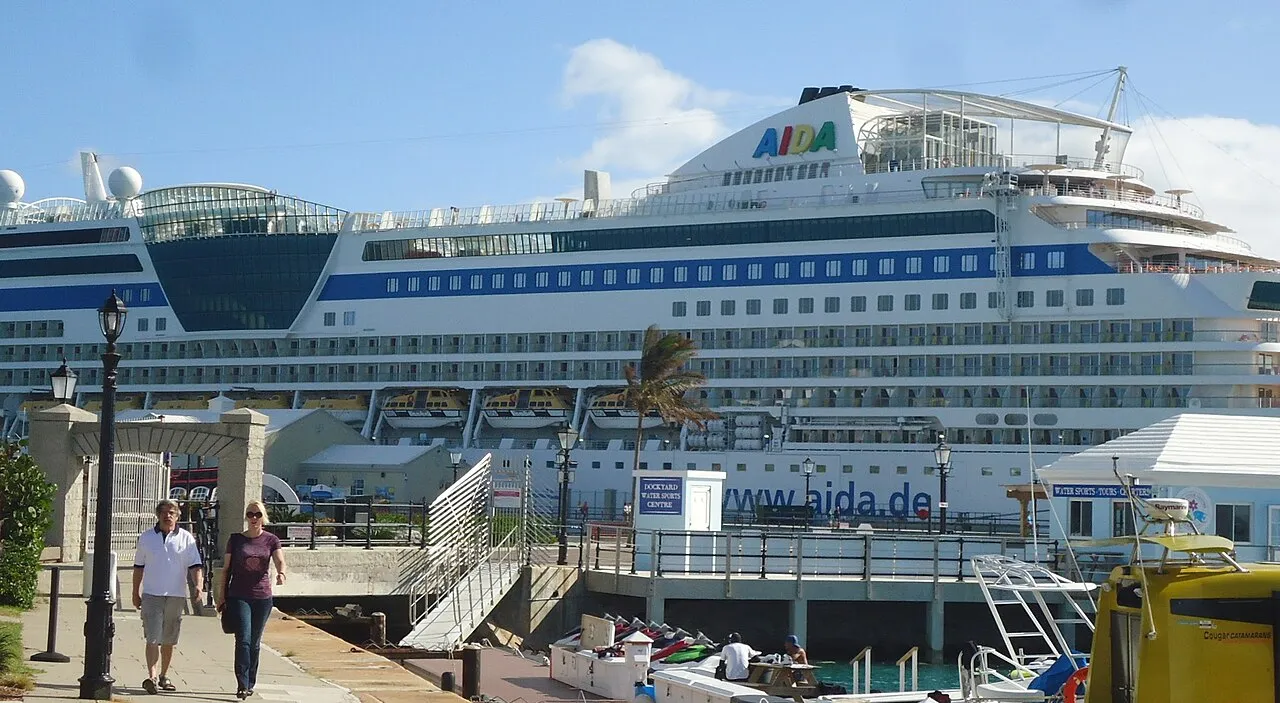 Royal Naval Dockyard fortress walls and clocktower with cruise ship berthed alongside historic limestone fortifications
