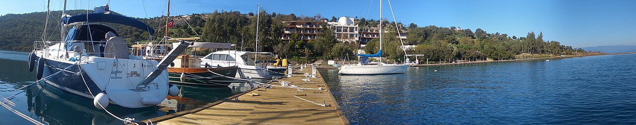 Whitewashed houses cascading down hillsides to turquoise Aegean waters with Bodrum Castle rising from the harbor