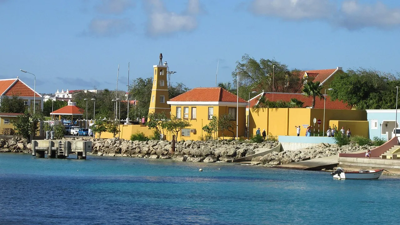 Cruise ship arriving at Bonaire with colorful waterfront buildings of Kralendijk and calm turquoise waters of the Caribbean Sea