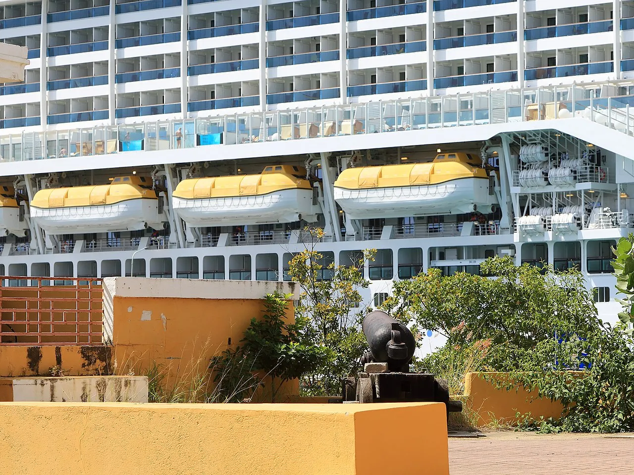 Flamingos wading in the shallow salt flats at Pekelmeer Sanctuary with white salt pyramids in the background