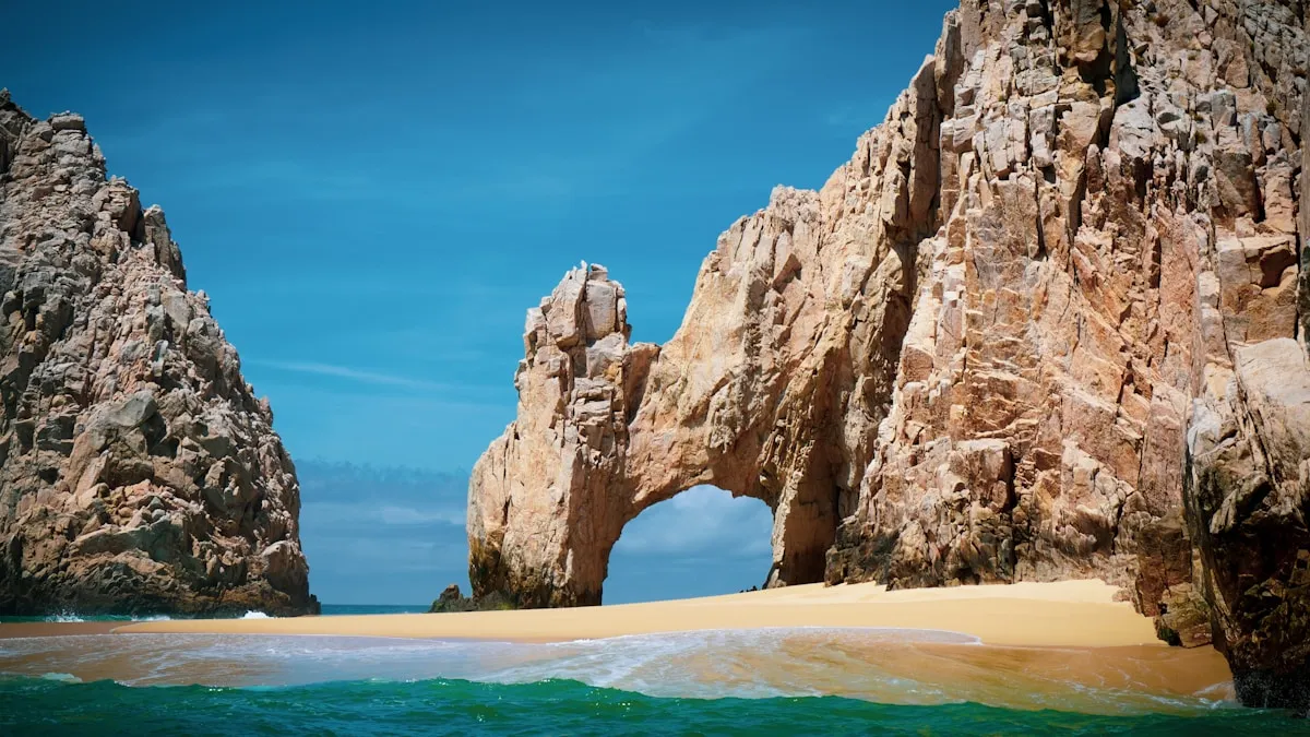 El Arco natural stone arch at Land's End with golden sand of Lover's Beach in the foreground and turquoise Sea of Cortez waters