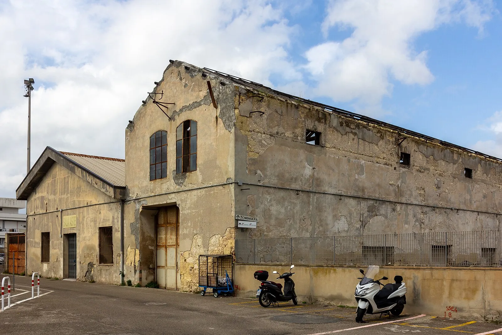 Old industrial warehouse near Cagliari port with Mensa F.S. sign