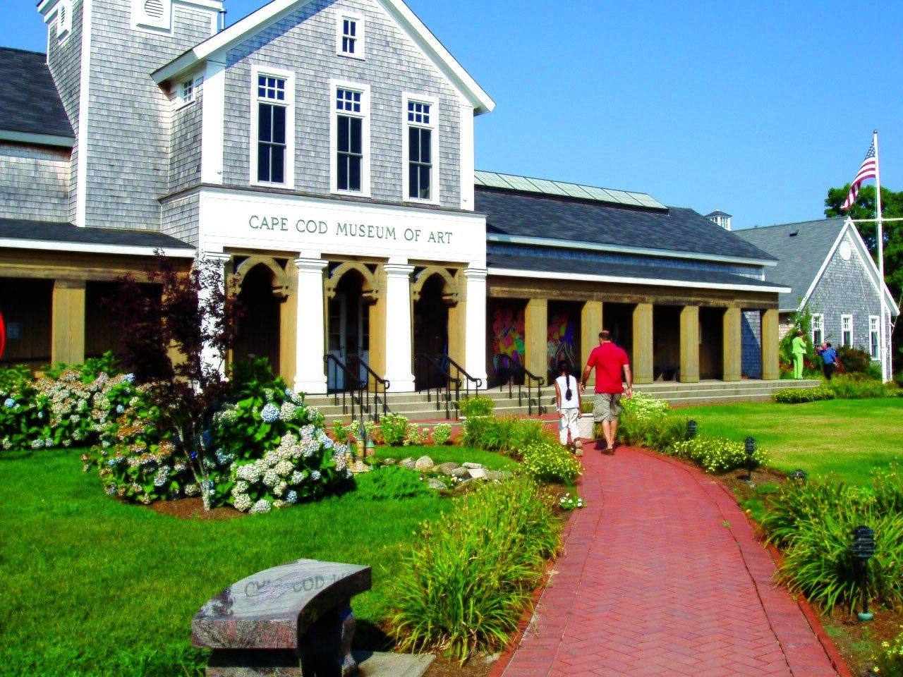 Cape Cod Museum of Art building with brick walkway, hydrangeas, and shingled New England architecture