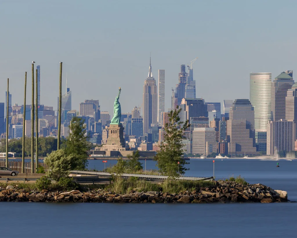 Liberty State Park walkway with Manhattan skyline and One World Trade Center in background