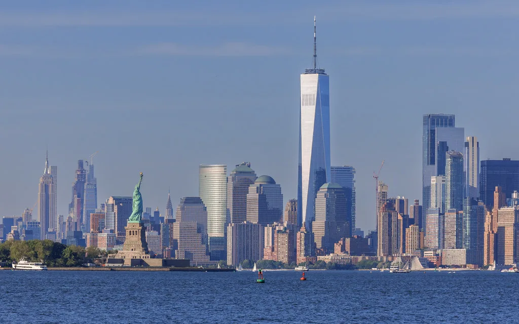 Cape Liberty cruise terminal in Bayonne, New Jersey with the Statue of Liberty and Manhattan skyline visible across New York Harbor
