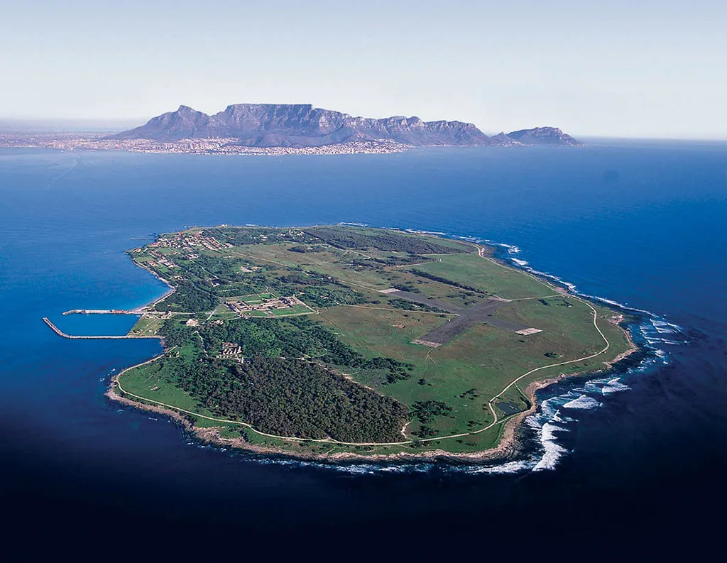Aerial view of Robben Island with Table Mountain and Cape Town visible across the bay