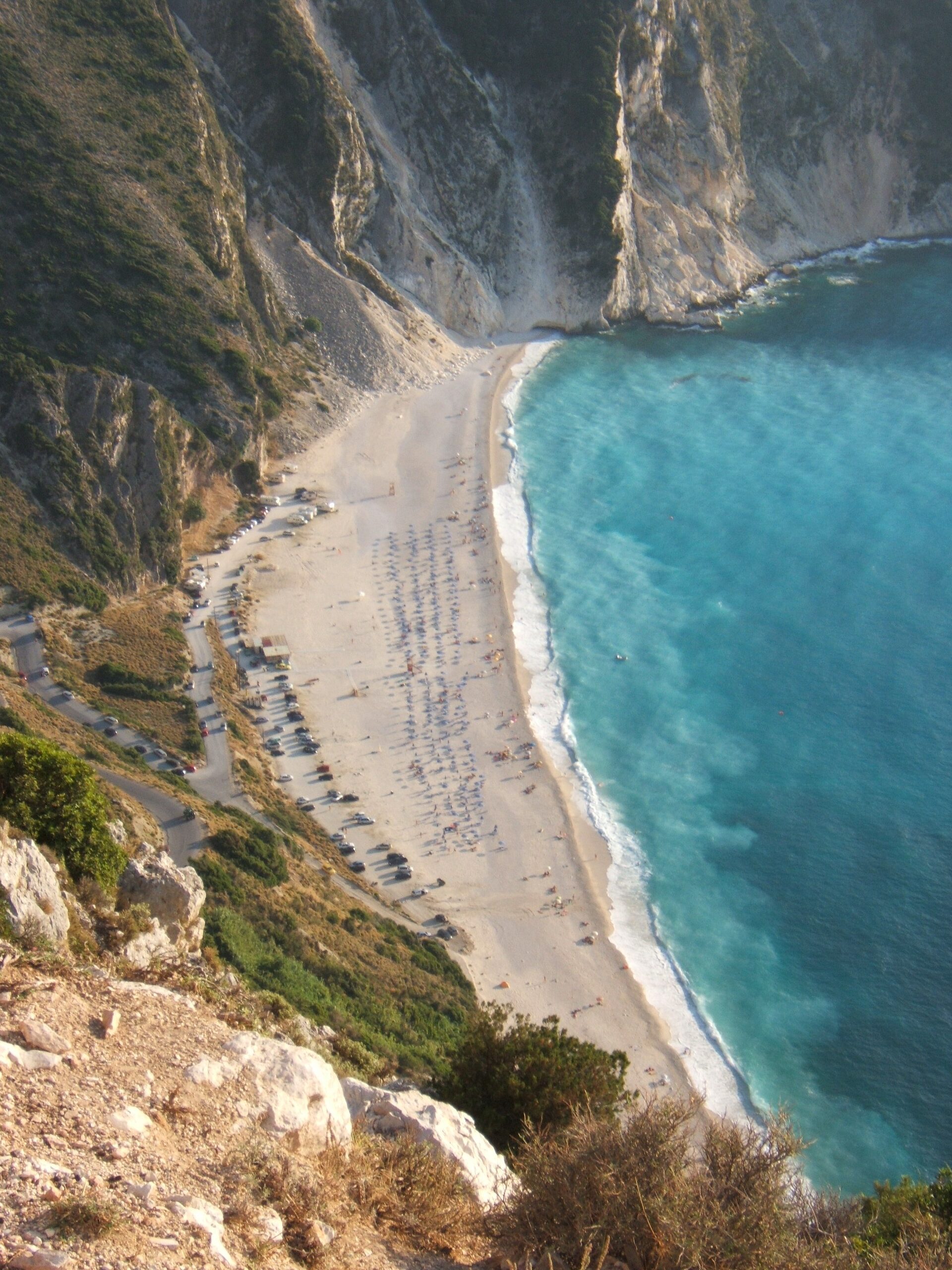 Myrtos Beach white limestone cliffs meeting turquoise Ionian Sea waters on Cephalonia island Greece