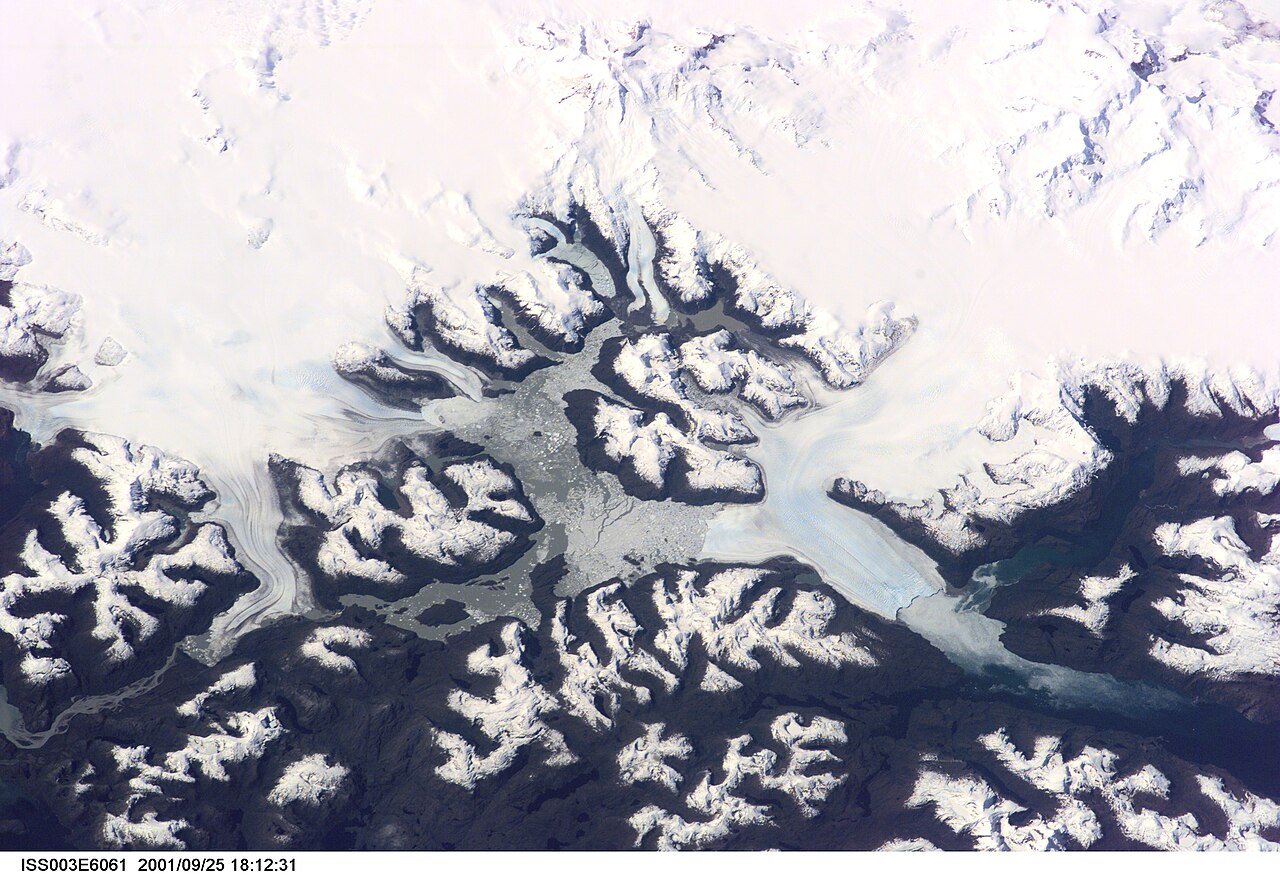 Granite peaks rising through mist above the fjord waters