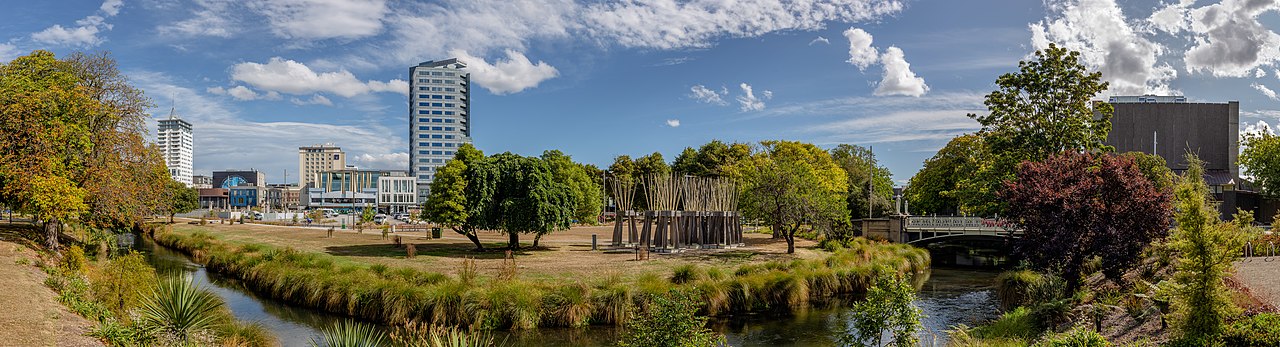 Panorama of rebuilt Christchurch along the Avon River with native plants and modern skyline