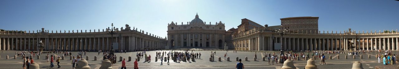 St. Peter's Basilica dome rising above Vatican City with crowds in the square below