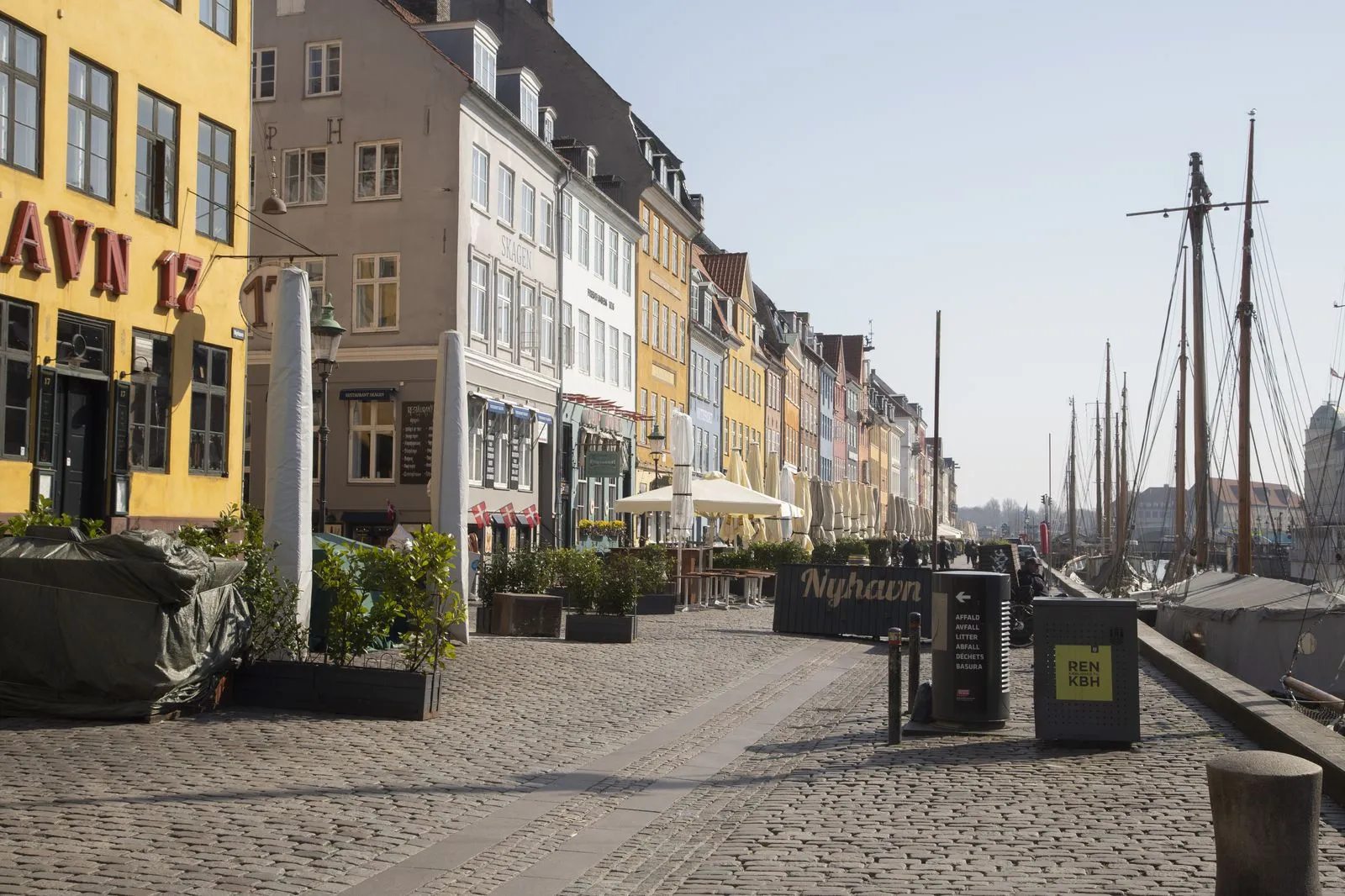 Canal boat tour passing colorful buildings in Copenhagen