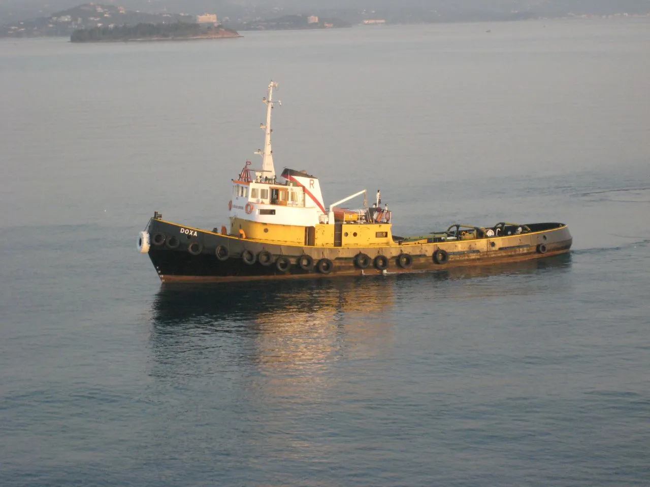 Venetian Old Fortress of Corfu rising above the azure Ionian Sea with cruise ship in harbor