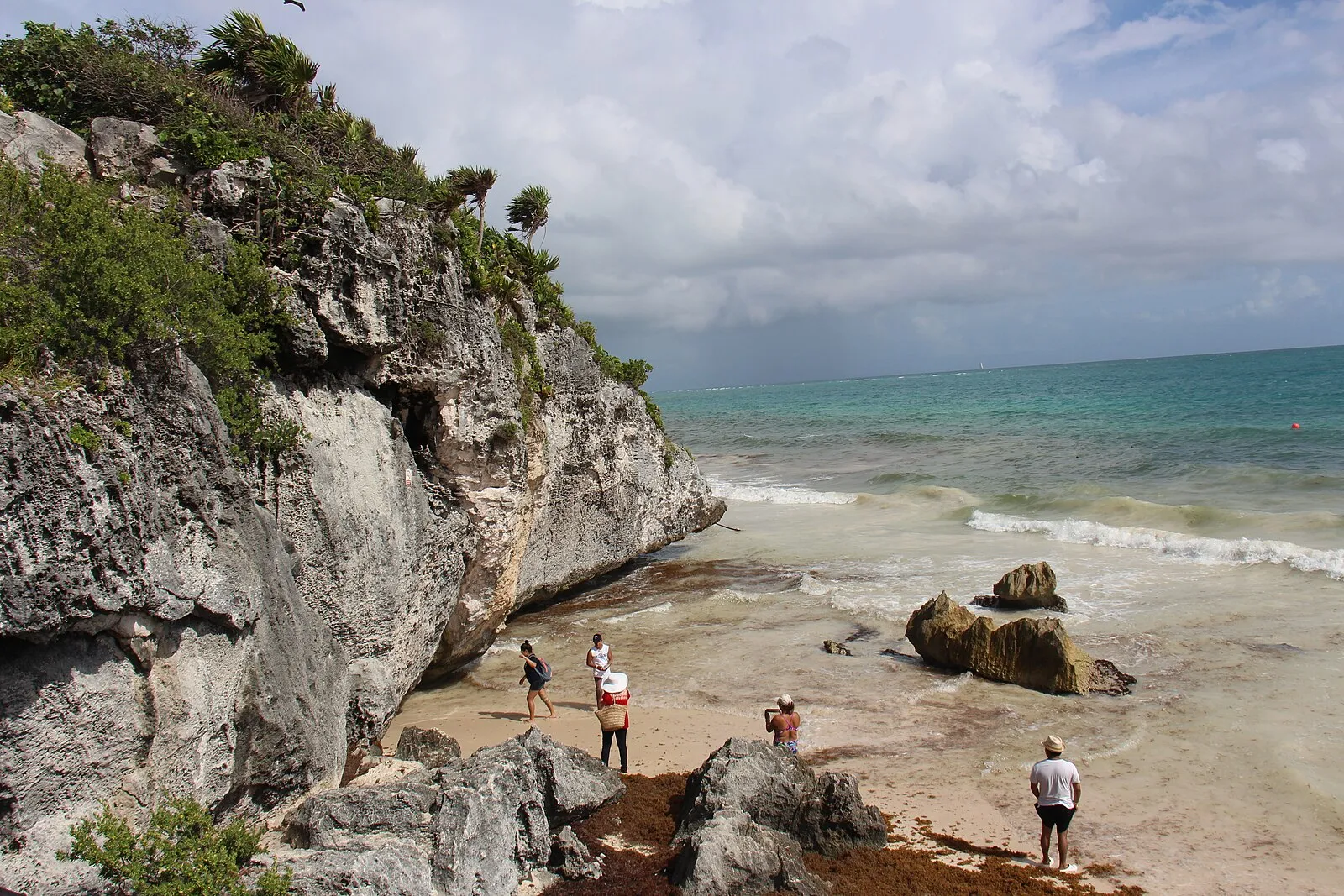 Tulum ruins cliffside with beach and Caribbean Sea
