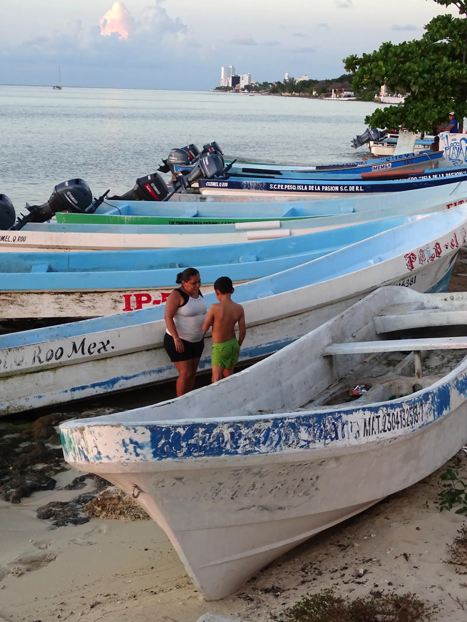 Traditional Mexican fishing boats on Cozumel beach with turquoise Caribbean waters