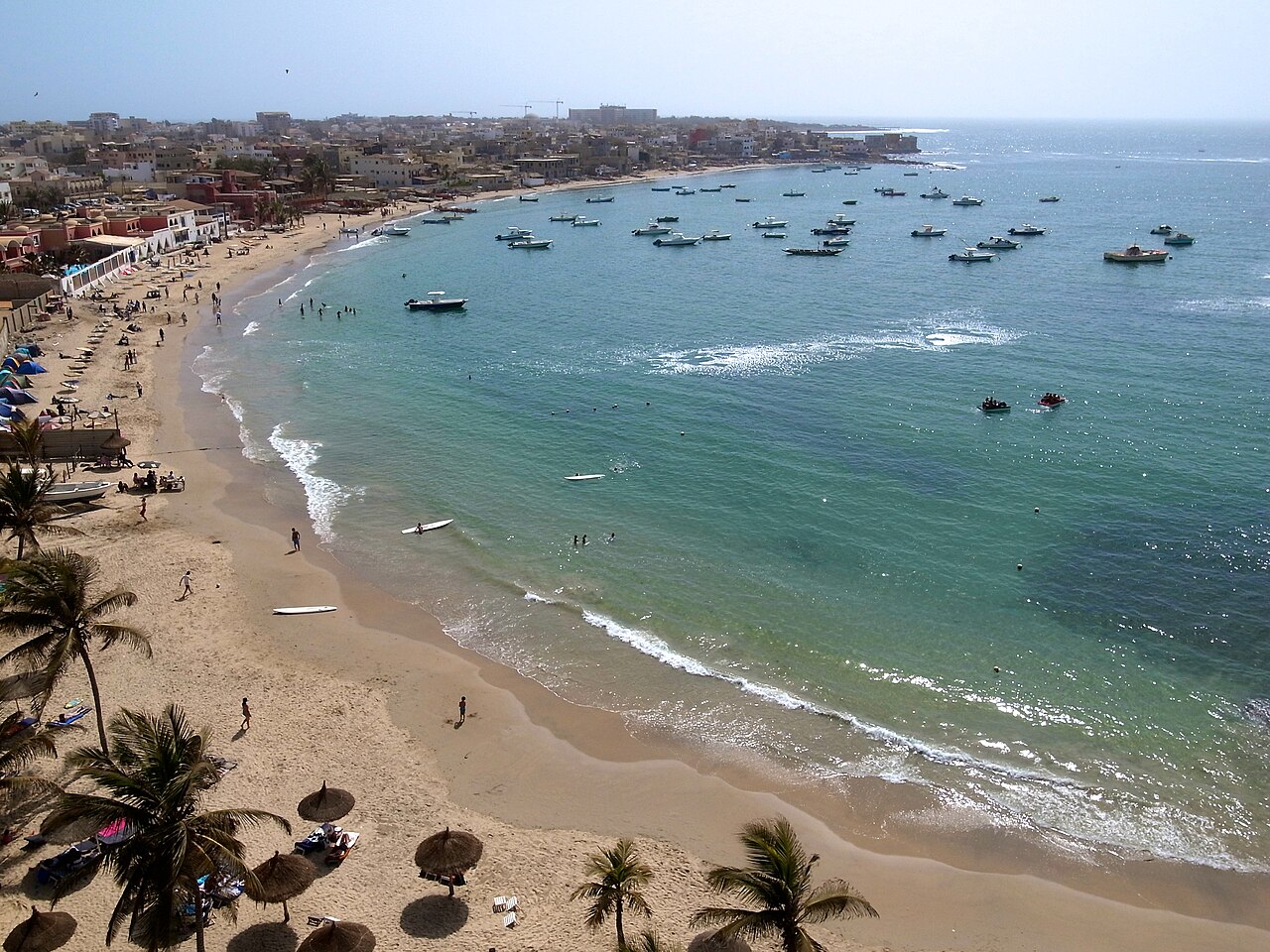 Aerial view of Dakar beach with fishing boats and palm trees