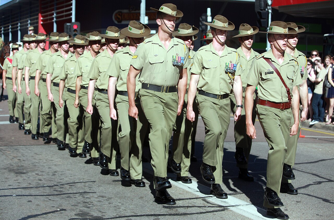 Australian soldiers in slouch hats marching in formation during ANZAC Day parade in Darwin