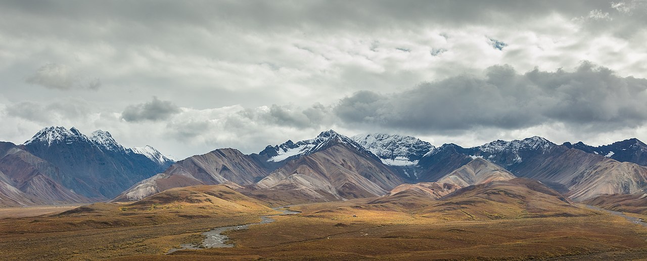 Wide panorama of Denali National Park landscape with mountains, tundra, and braided rivers