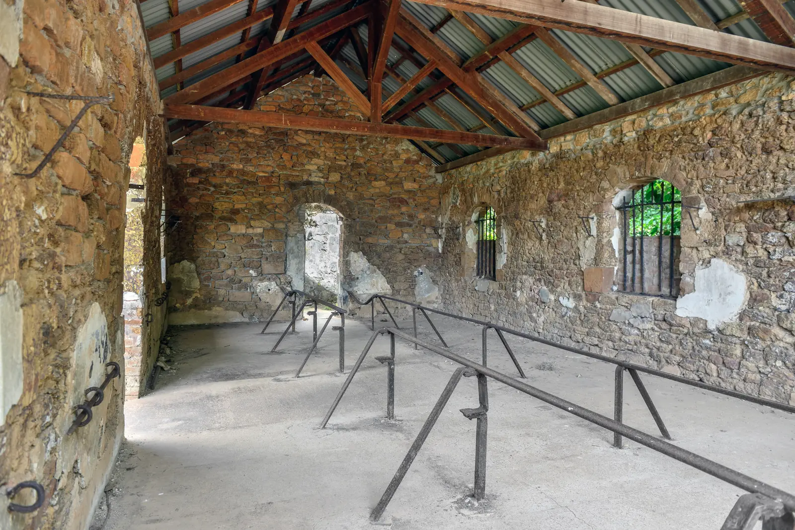 Inside a convict dormitory on Île Royale, with the iron bars still running along the floor where men were shackled