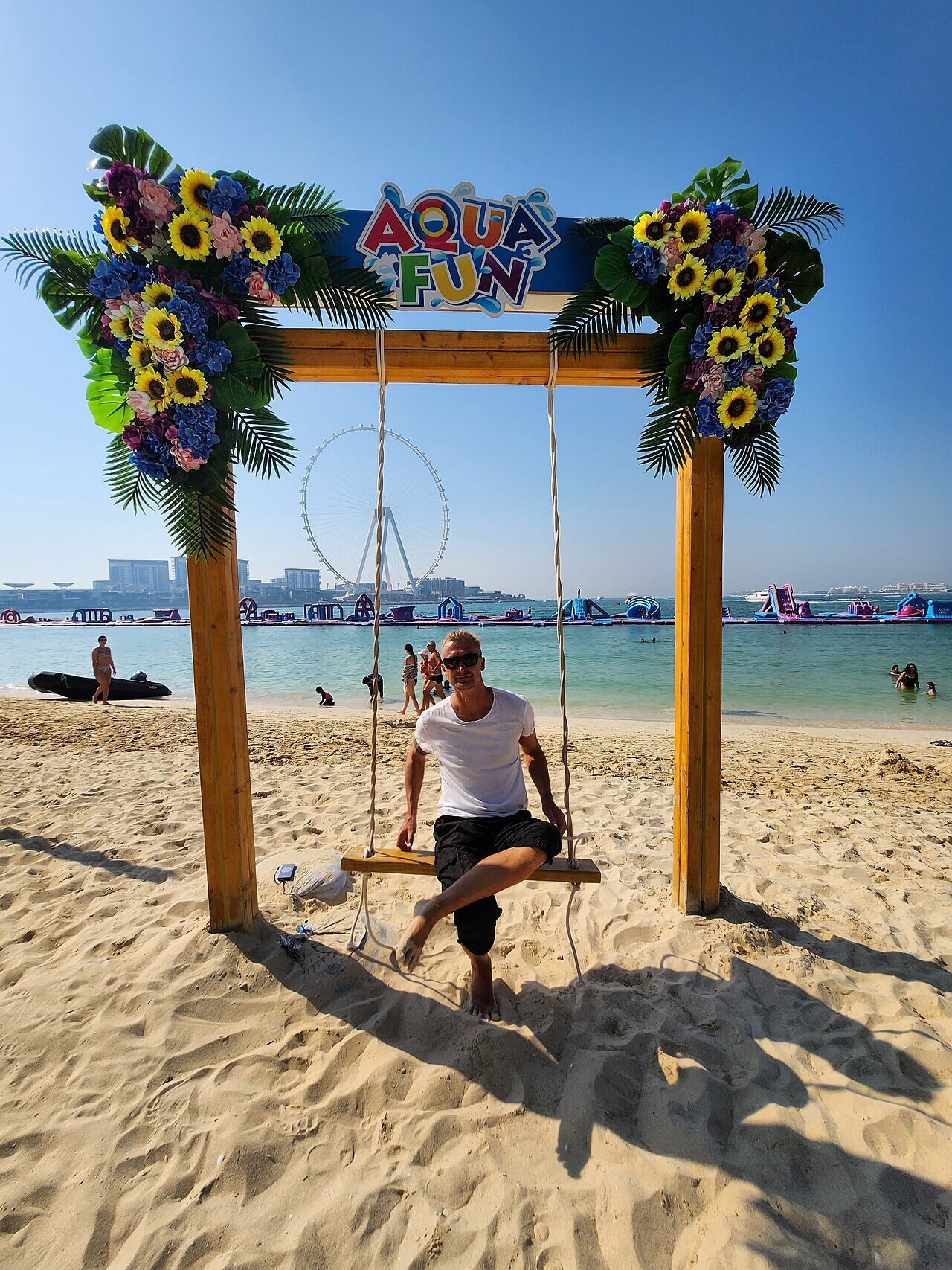 Aqua Fun beach swing at JBR with Ain Dubai observation wheel visible in the background
