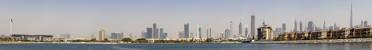 Dubai skyline featuring Burj Khalifa towering over the city at sunset with Arabian Gulf waters in the foreground