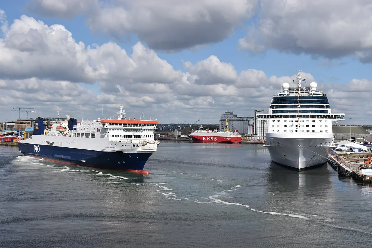 P&O ferry departing Dublin Port alongside a docked cruise ship with container vessels in the background