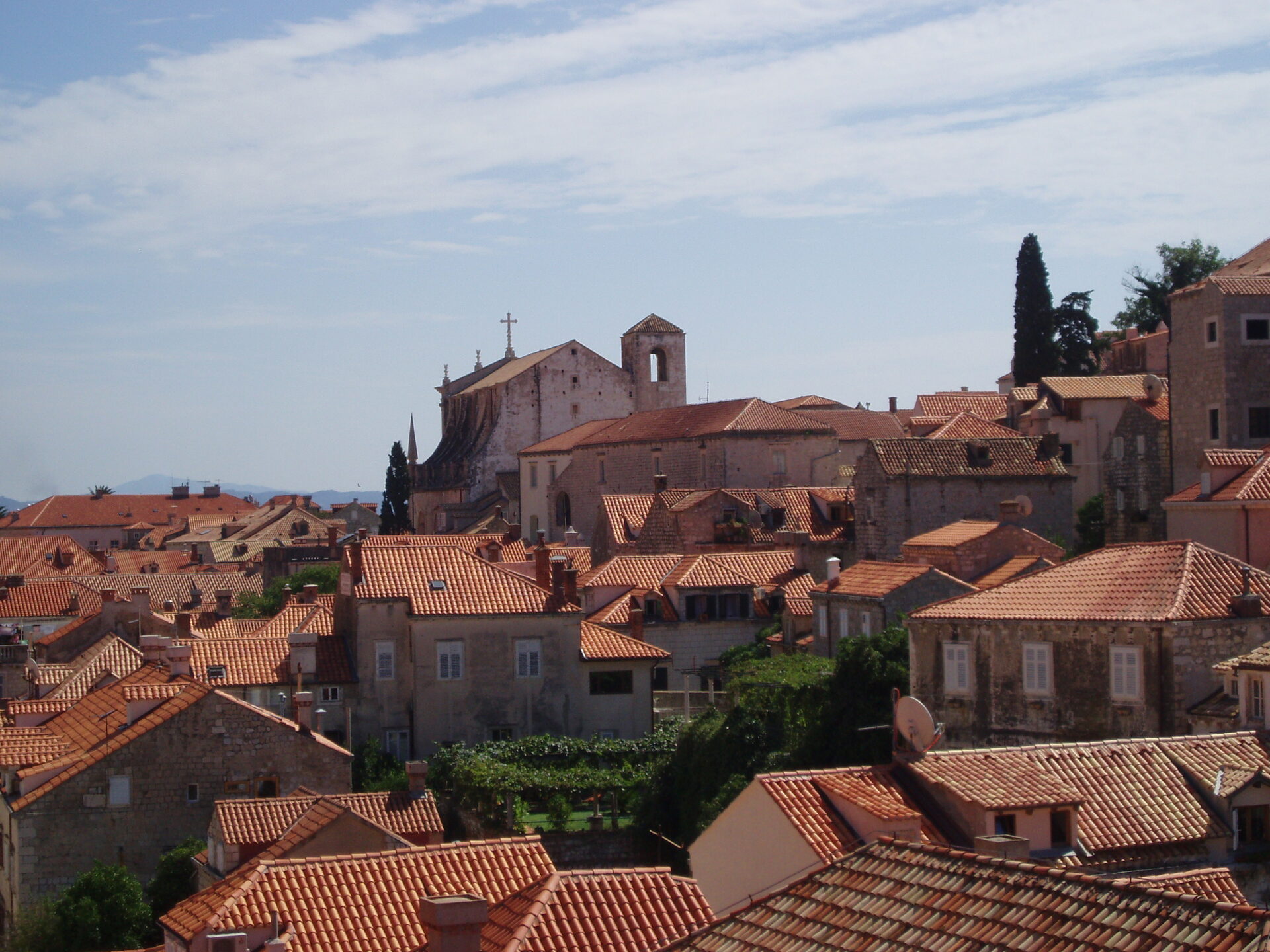 Dubrovnik rooftop panorama with terracotta tiles and medieval church rising above the Old Town