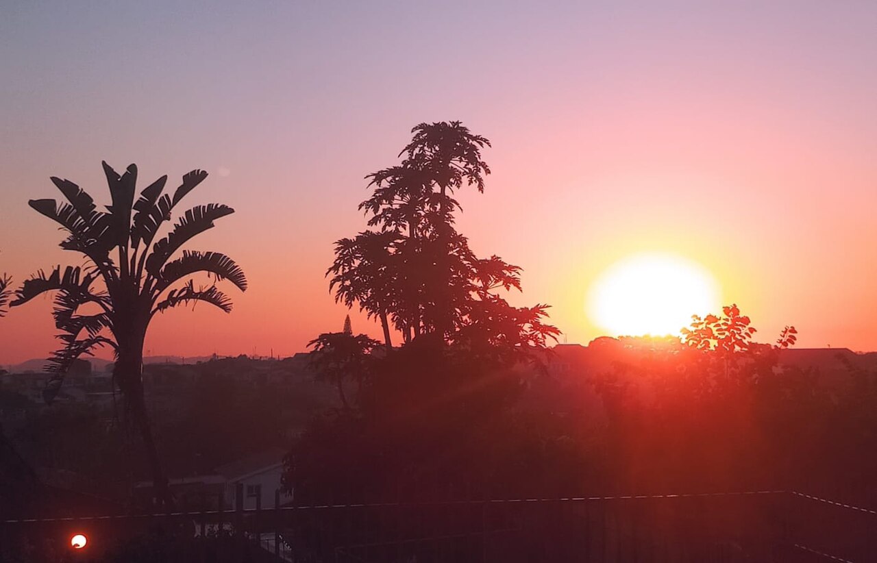 Vibrant sunset over Durban's Indian Ocean coastline with golden light reflecting off the warm tropical waters