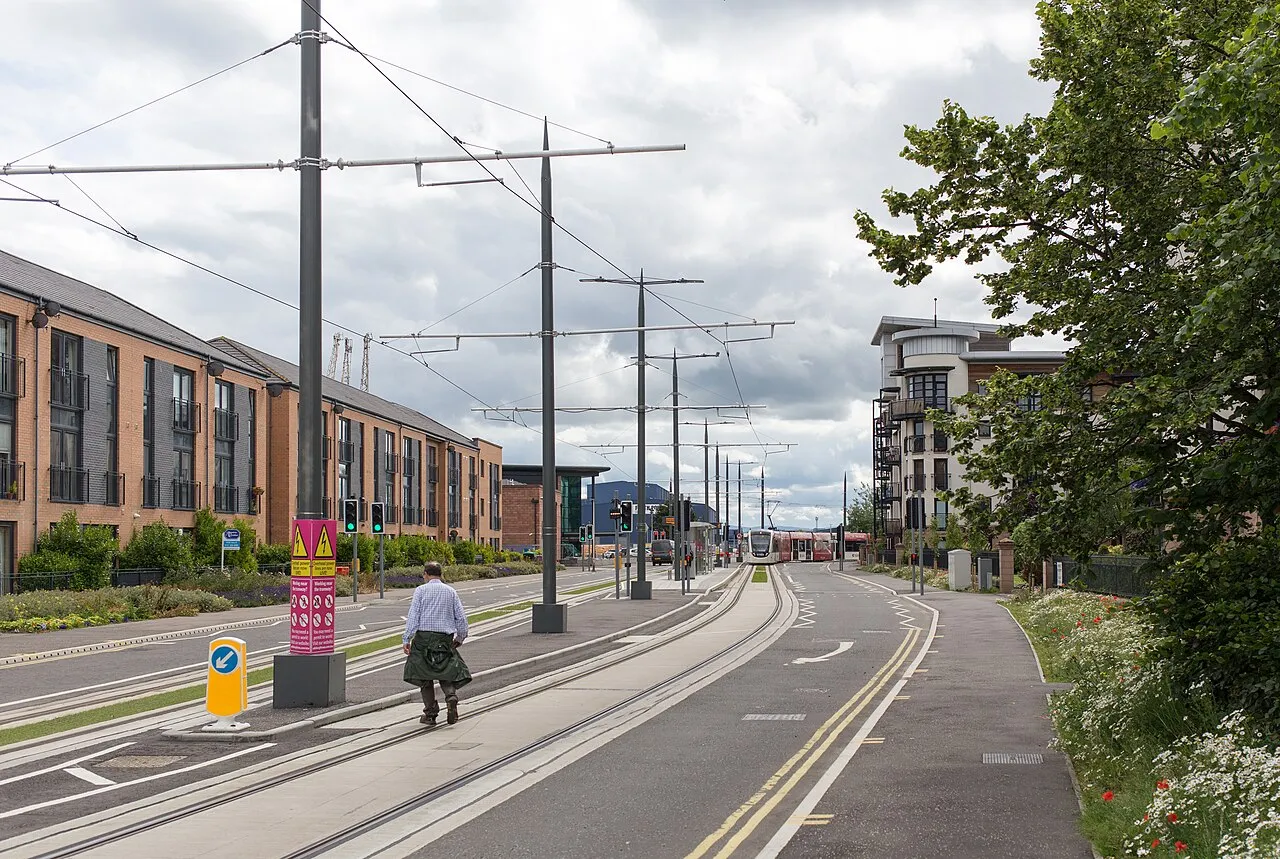 Edinburgh Castle perched on volcanic rock above the city with Scottish flag flying in the wind