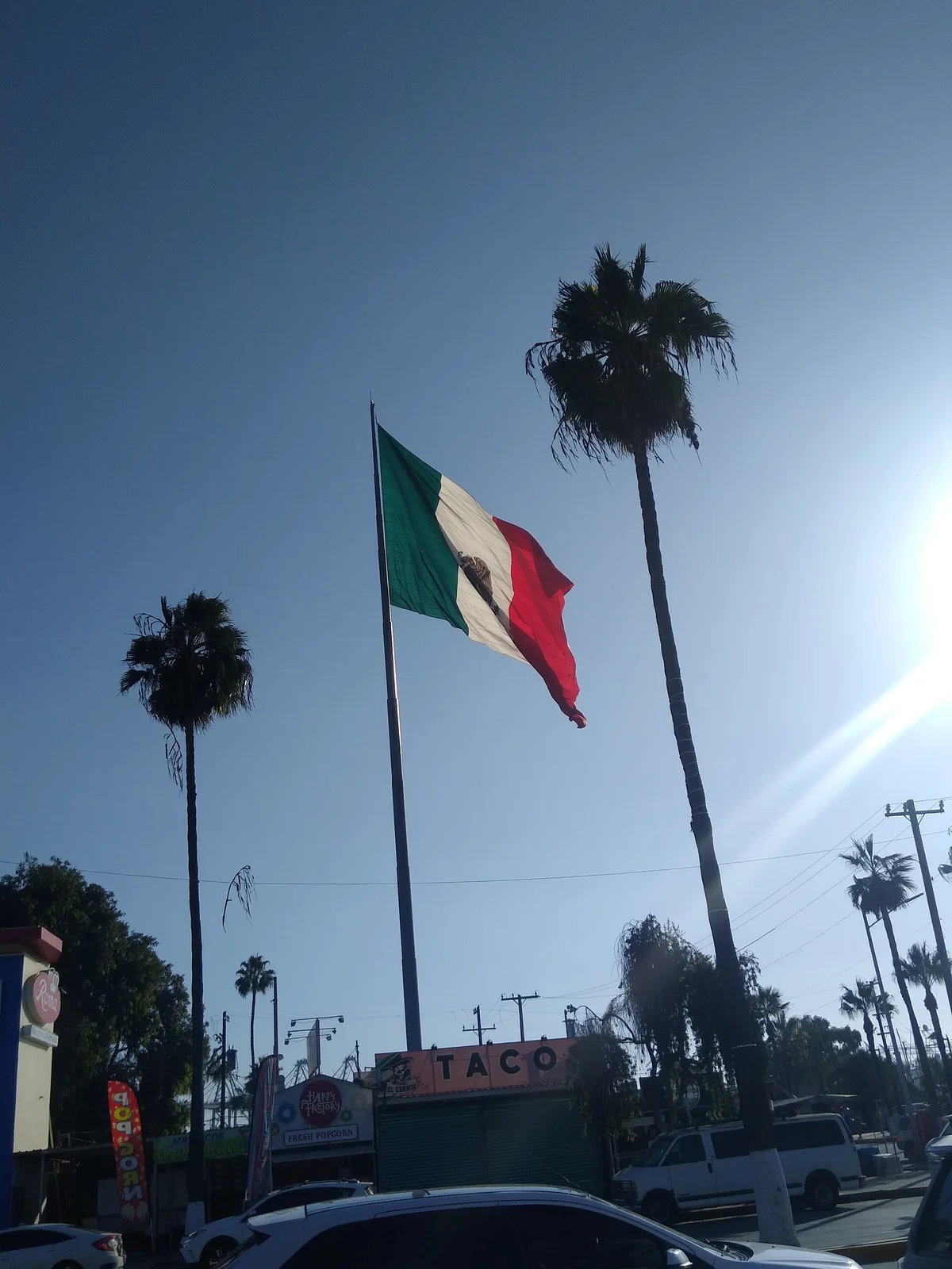 Giant Mexican flag flying high on massive flagpole at Ensenada waterfront landmark