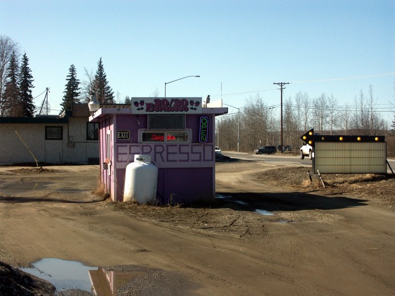 Purple drive-through espresso hut on roadside in Fairbanks, Alaska with pickup truck in line