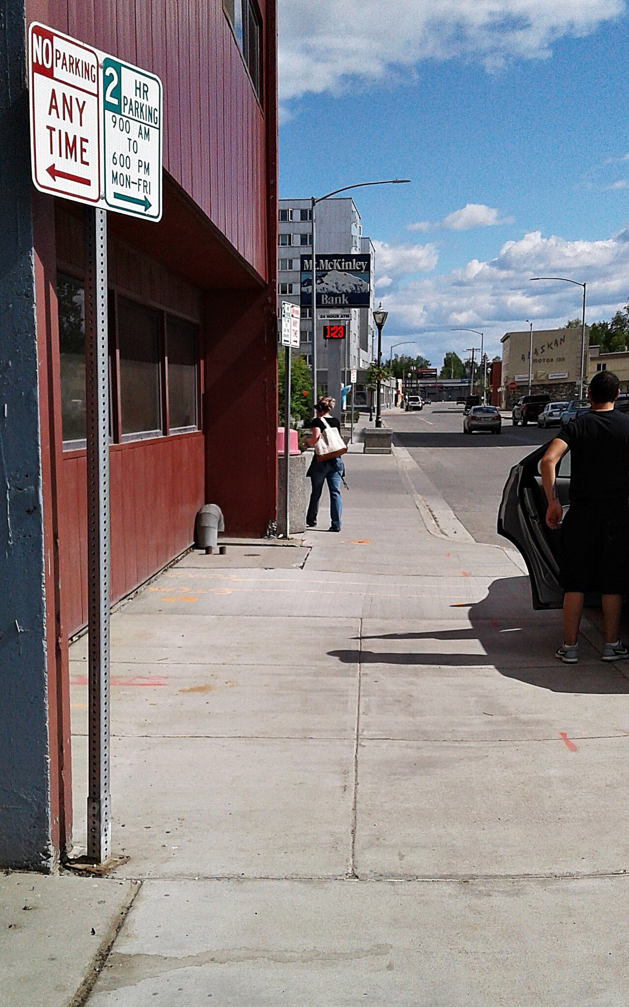 Fourth Avenue sidewalk in downtown Fairbanks, Alaska, looking east toward Lacey Street with Mt. McKinley Bank sign and the Northward Building