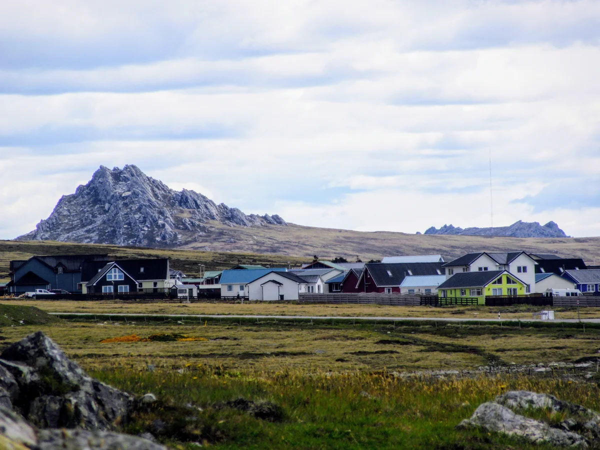 Traditional houses on hillside in Stanley with corrugated iron roofs in various colors